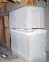 Concrete crawl space support posts in Kennett Square that are showing signs of failure as they sink into the earth.