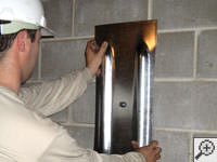 Mounting a foundation wall plate for an earth anchor installation in Claymont.
