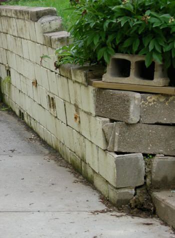 collapsing retaining wall with severe damage in Milford