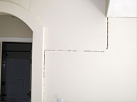 Drywall cracking due to foundation settlement in Highland Acres