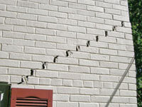 Stair-step cracks showing in a home foundation in West Grove
