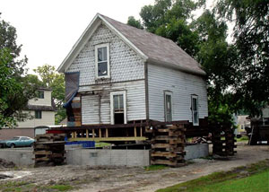 A severely damaged home foundation that is undergoing replacement in Greenville .