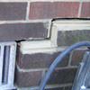 A closeup of a failed tuckpointing job where the brick cracked on a Rehoboth Beach  home.