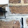 Failed crack repair showing old tuckpointing that cracked on a Dover home.