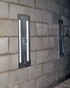 an inside view of foundation wall anchors installed along a basement wall to brace and repair the structure in Brookhaven 
